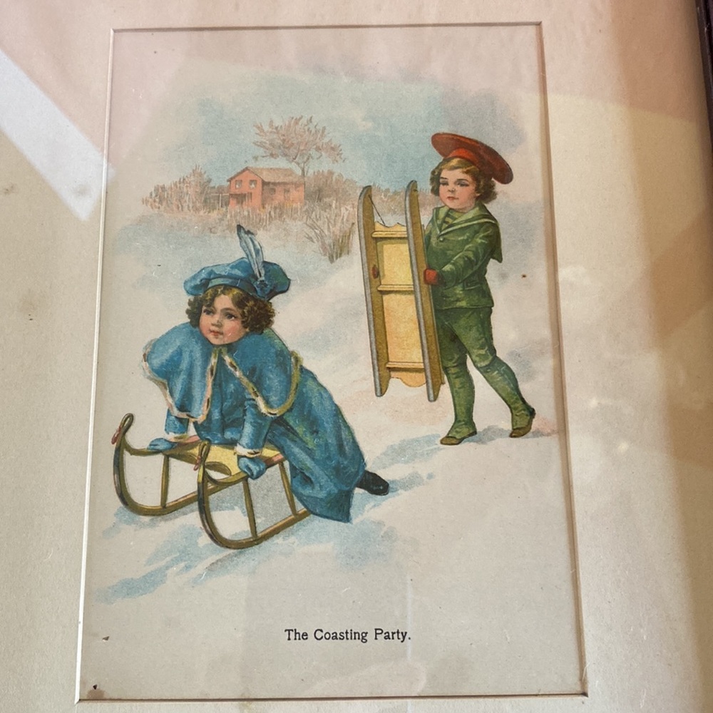 Antique sledding child themed matted print in dark stained wood frame